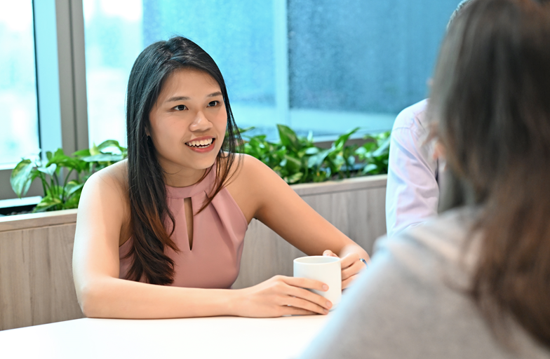 Older hands handing earth to younger hands 