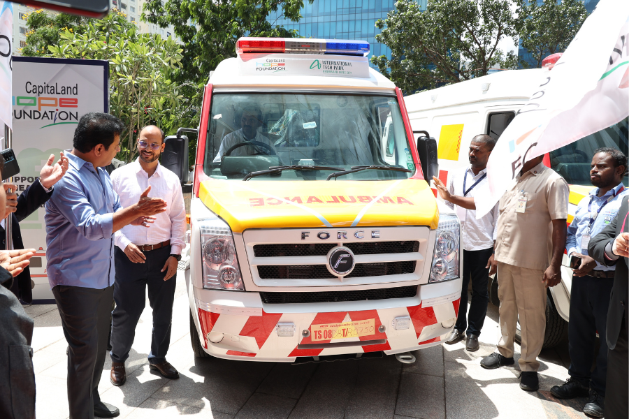 A group of men standing around the ambulances